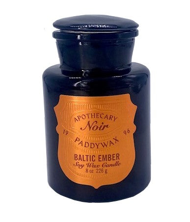 This apothecary noir candle has an air of sophistication. Featuring the same iconic shape of an old-world apothecary bottle, which emits an amber glow to set a warm, mystical tone in your space. Fragrance: Top Notes: Cade Oil, Wood, Middle Notes: Spices, Musky, Base Notes: Cedarwood, Vetiver, Woody. 8 oz.  3" x 3" x 5"