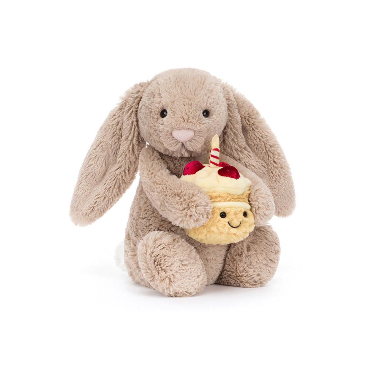 Plush Jellycat bashful bunny holding a plush cupcake with a candle on a white background