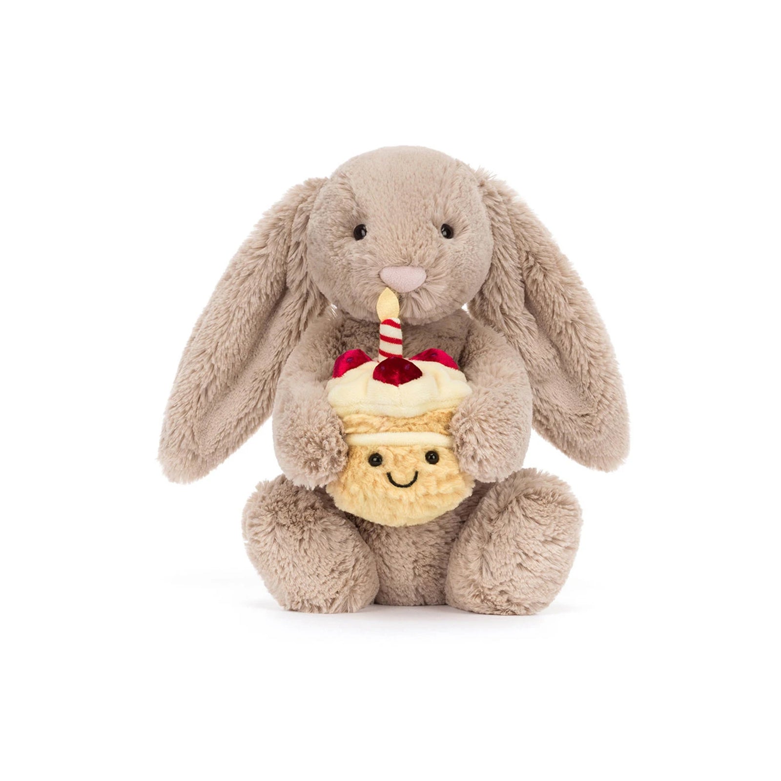Plush Jellycat bashful bunny holding a plush cupcake with a candle on a white background