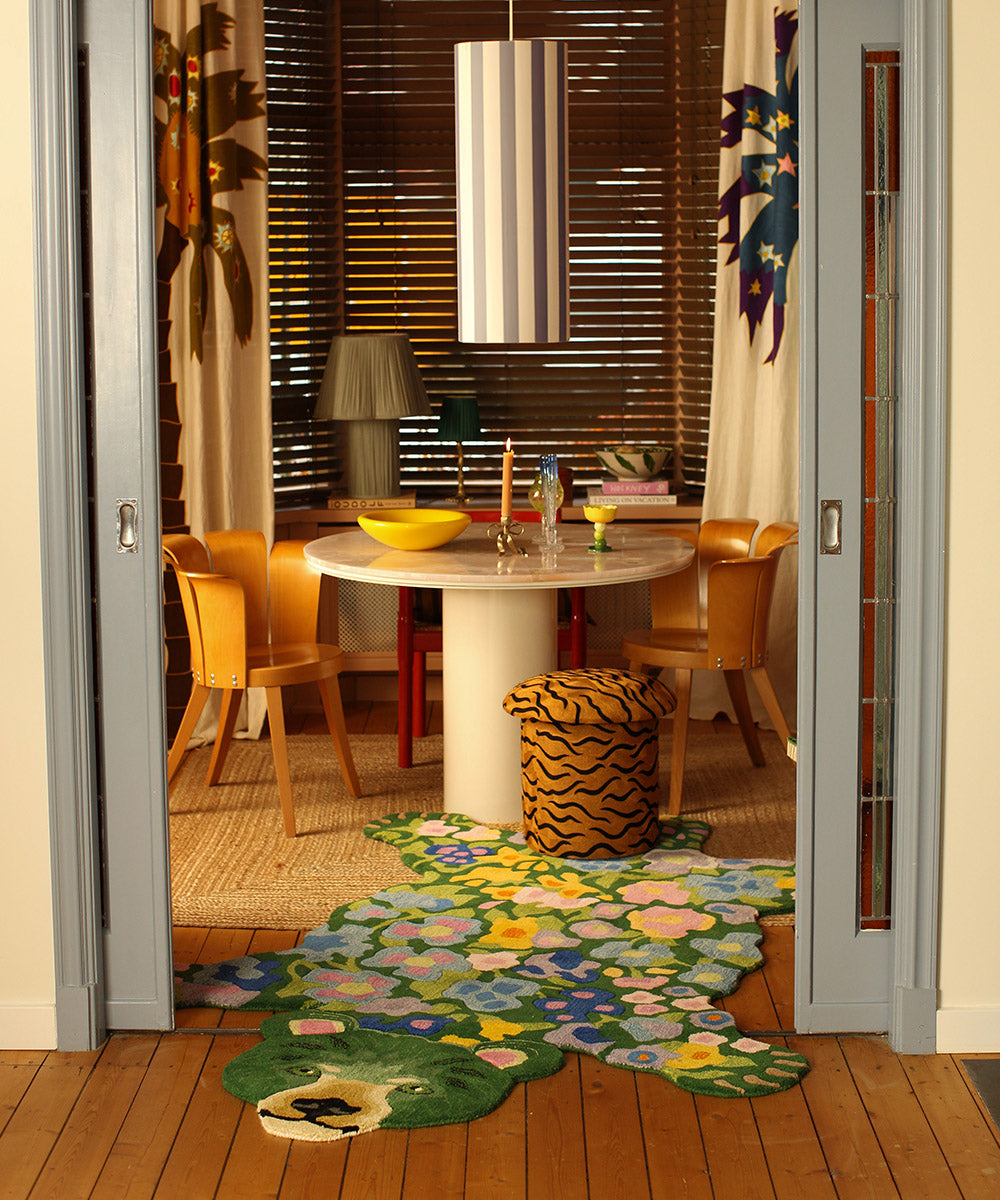Dining room with a floral rug on the wooden floor