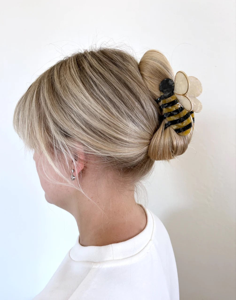 You'll be super buzz-y accepting compliments with this bumble bee hair clip. It is double sided for a perfect look from every angle. Unlike most plastic accessories, these small-batch styles are made from a biodegradable wood pulp acetate, making these clips both beautiful and kind to the environment! Size: 3" x 2".