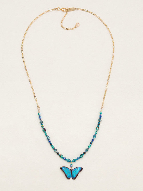 Add a flutter of irridescent color to your look with this stunning blue butterfly necklace. Hand threaded accent beads compliment the butterfly charm. • Niobium • Gold filled chain • Chain length 16", adjustable to 18"