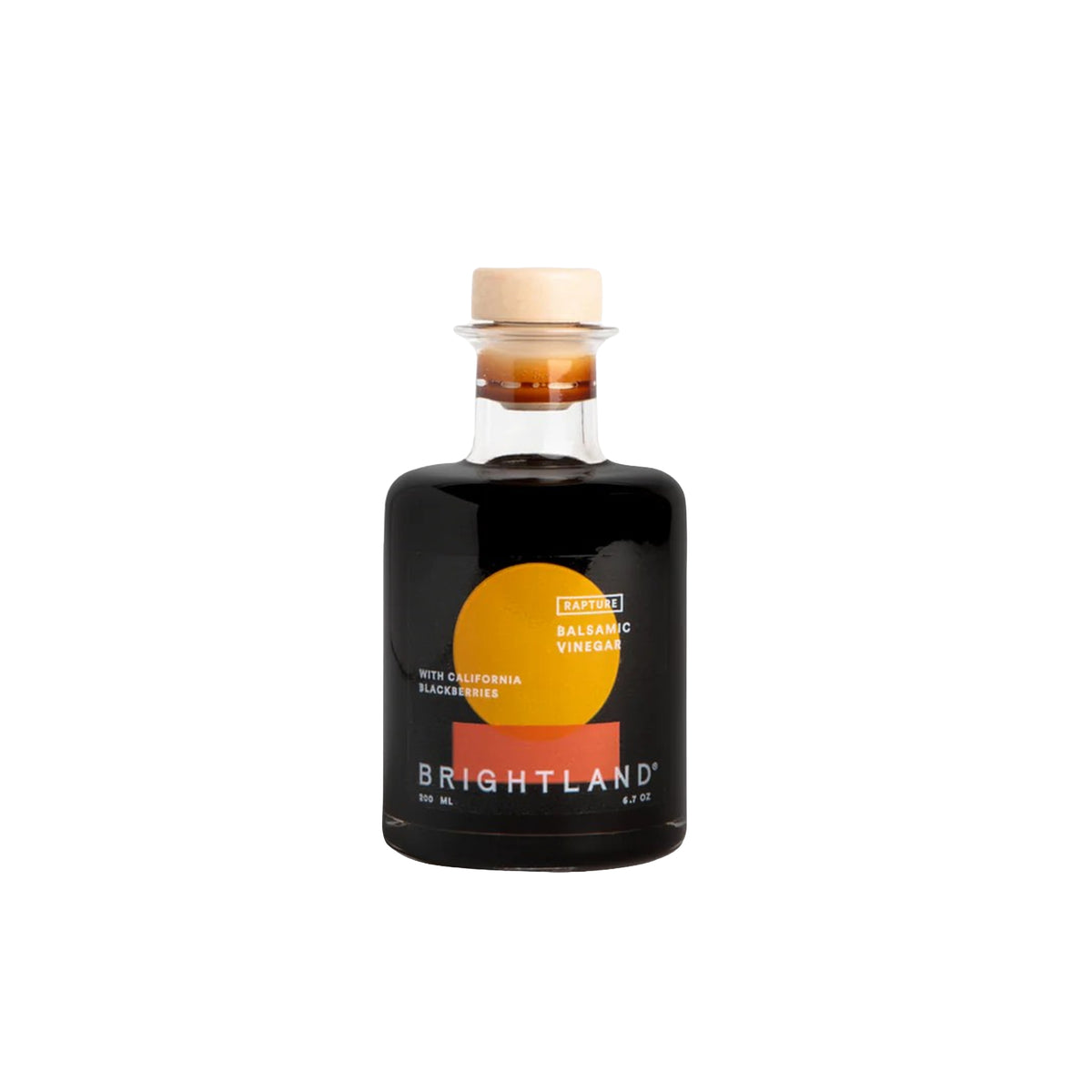 Brightland California Blackberry Balsamic Vinegar in a clear glass bottle with a black label, featuring a yellow and orange sun graphic, and a light wood cork stopper, on a white background.