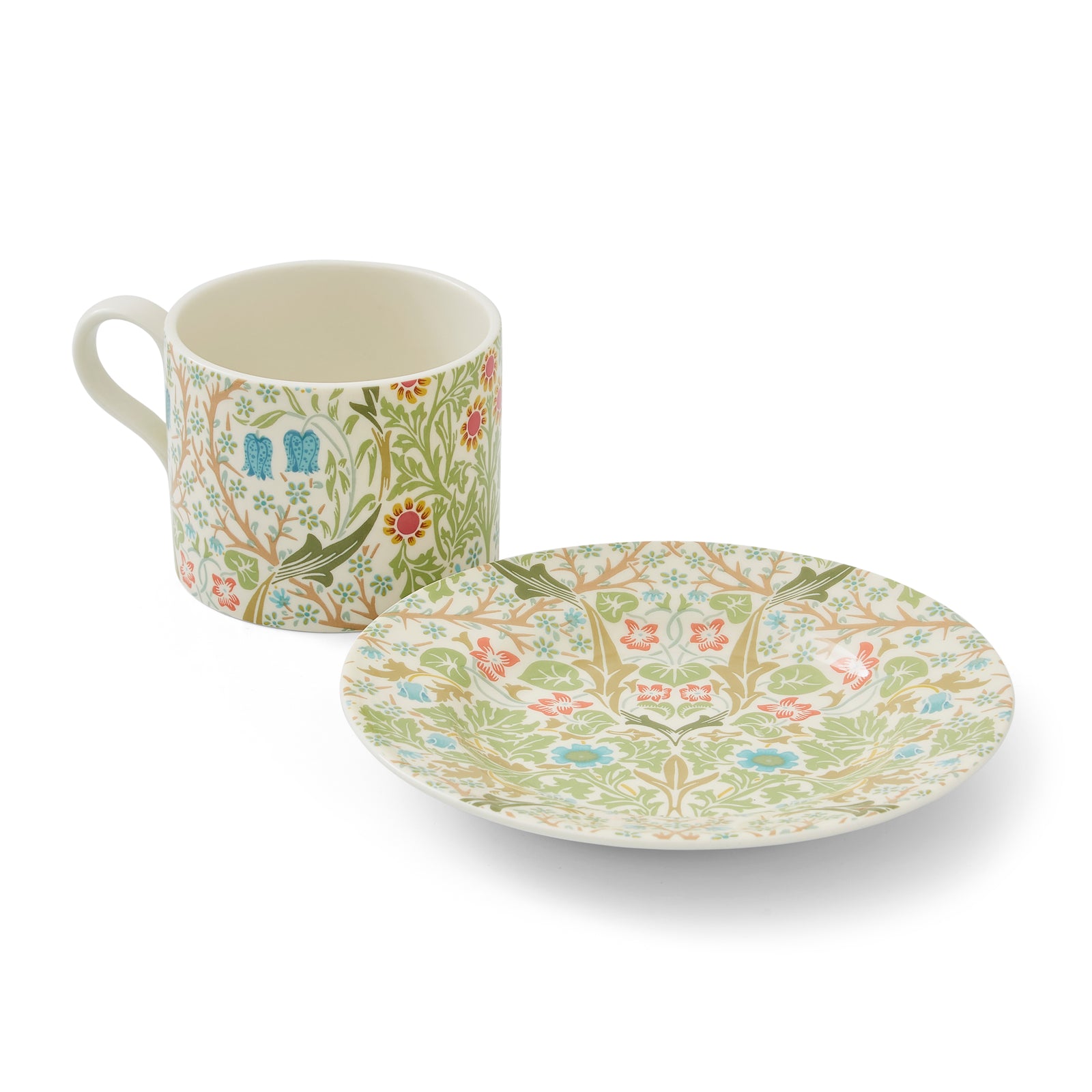 A teacup and saucer set with a floral pattern, featuring the William Morris print 'Blackthorn' with predominantly green leaves and colorful flowers.