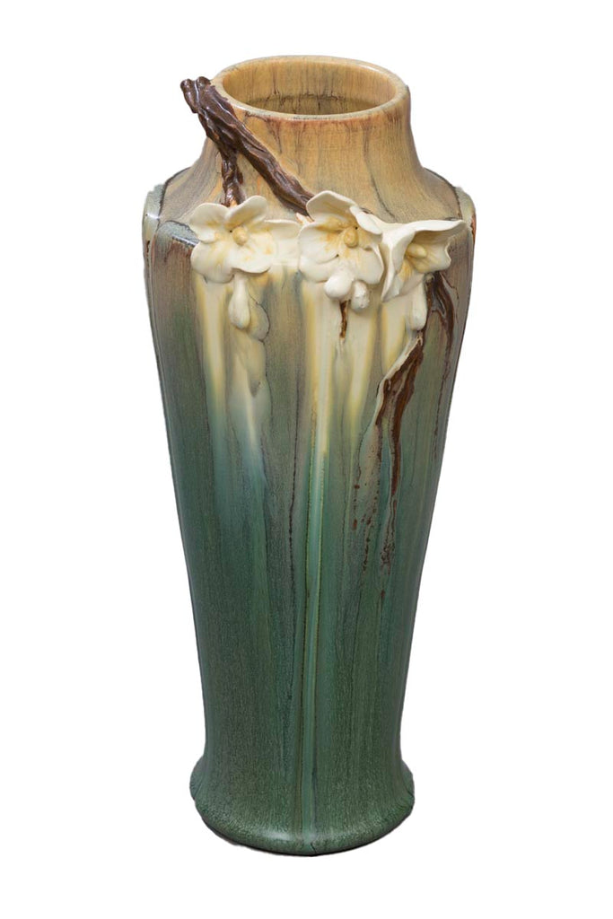 Before leaves broaden and fruit forms, trees greet spring with their beautiful blooming branches. This vase celebrates the dramatic beauty of a single blooming branch, which rests on the shoulder of a subtle and elegant, architectural vase. Thrown, sculpted and glazed by hand Size approx. 12" x 5".