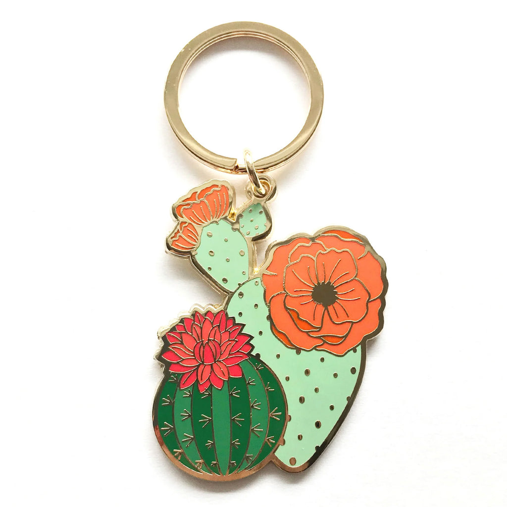 Show your love for The Huntington's Desert Garden, and all cacti and succulents with this gorgeous blooming cactus keychain. It features high quality, vibrant enamel on a sturdy key chain, all luxuriously gold plated for extra shine 1.84 in. x 4 in. Hard Enamel Keychain. High Polished Gold Plated.