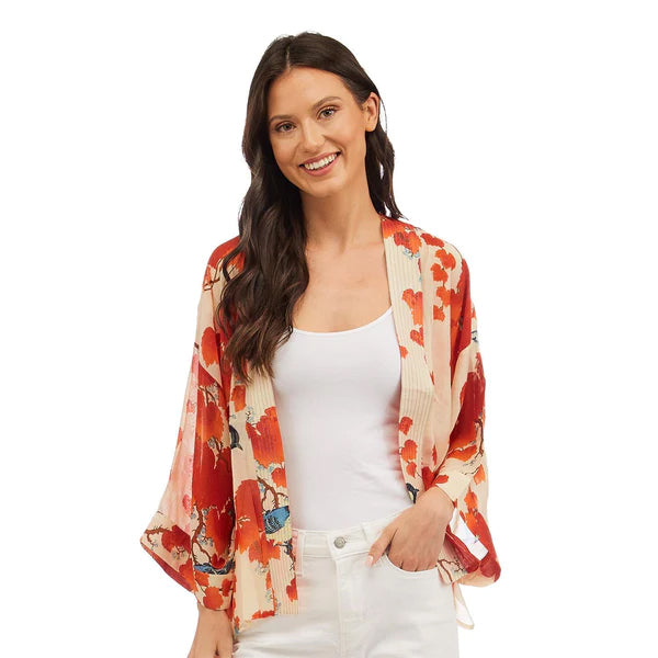 This gorgeous, vibrant print features the beautiful ornamental foliage of the Japanese maple tree with bold scarlet and orange tones and colorful birds on a rich ivory base. This one-size, loose-fitting kimono style jacket has ¾ length sleeves, an open front and a lightly embroidered lapel. One-Size Fits Most.