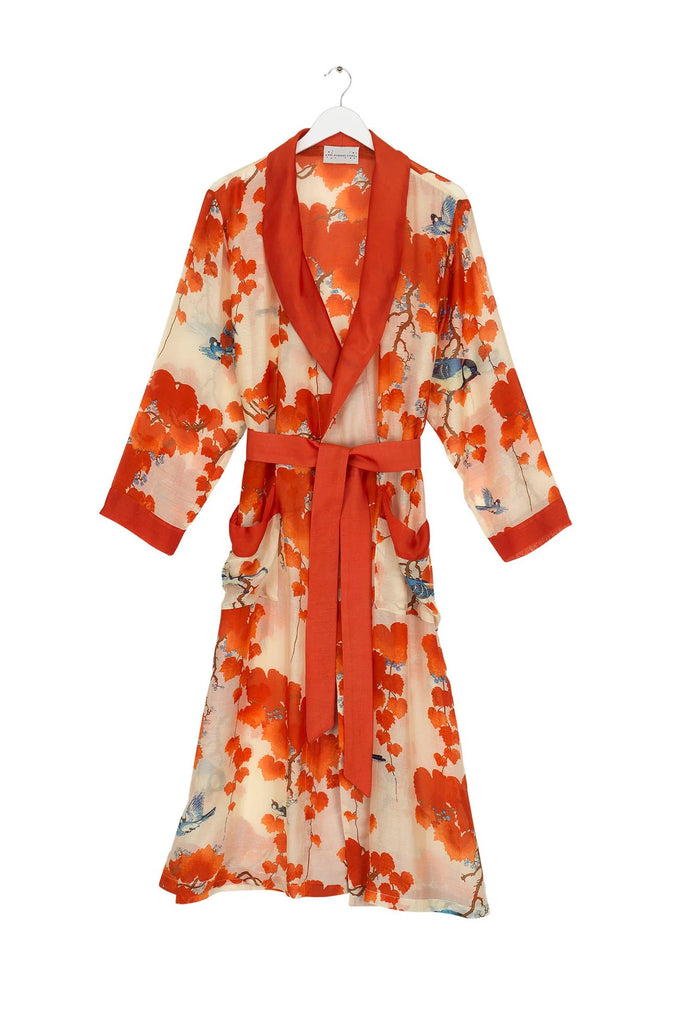 This vibrant print features the beautiful ornamental foliage of the Japanese maple tree with bold scarlet and orange tones and colorful birds on a rich ivory base. This soft, lightweight gown is long for an elegant look and features a silky soft tie waist belt for a flattering fit. 50% modal, 50% viscose. ONE SIZE.