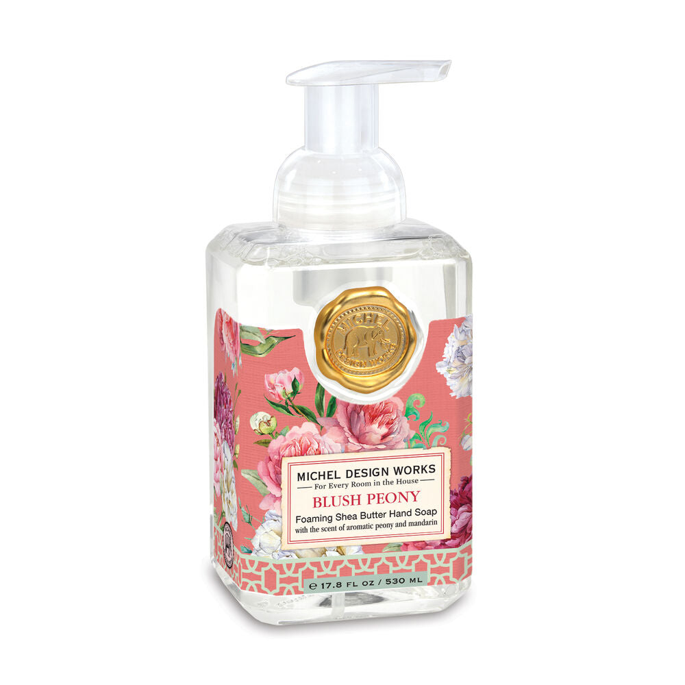 Foaming hand soap bottle with floral design on a white background