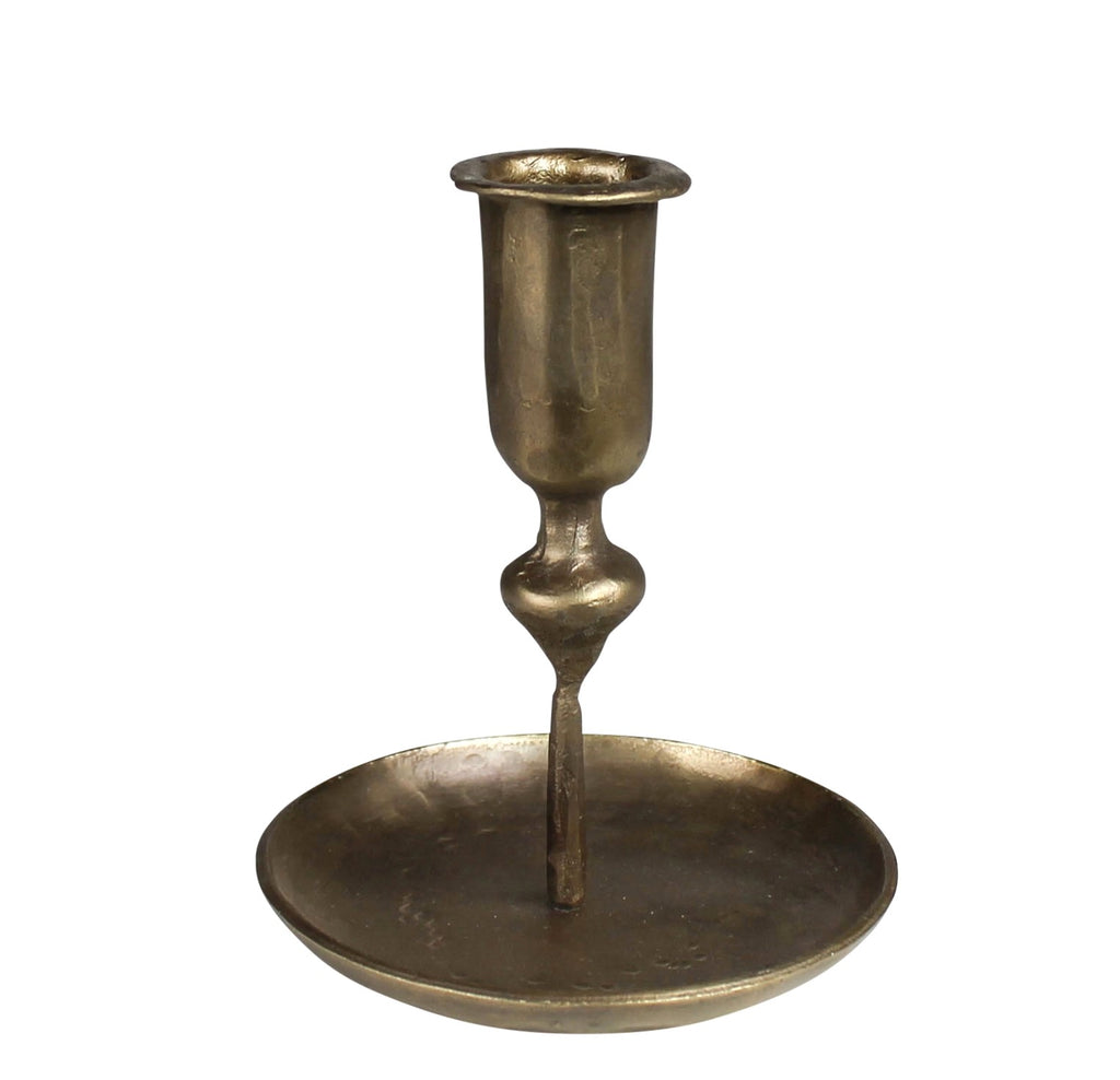 This classically styled, brass-plated candlestick has an antique style rustic hammered finish. Add one or two to a table setting for an understated elegant touch. Layer more for a more dramatic tableau. Brass plated candlestick/ candle holder Fits standard sized tapers Dimensions: 4.5" x 4.25"