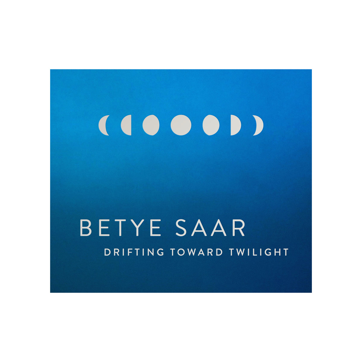Blue book cover with white text and moon phase symbols for Betye Saar's 'Drifting Toward Twilight'.