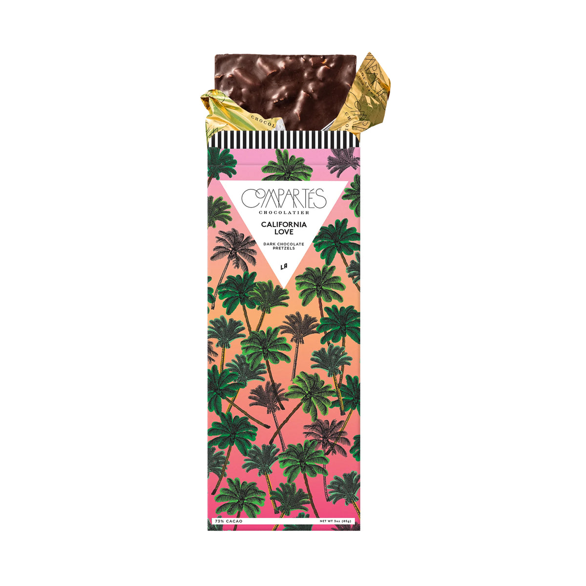 A wrapped chocolate bar from The Chocolate Company, featuring a tropical palm tree pattern in green, pink, and orange, with a gold foil wrapper peeking out at the top.