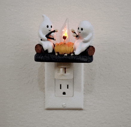 This playful nightlight adds a touch of fun to your room with its ghostly glow. Features two cute ghosts, roasting marshmallows around a cozy flickering campfire. Perfect for creating a warm glow or as a quirky nightlight for kids. Plugs into any standard 120v outlet. 360-degree swivel mount with on/off switch. 4.25" x 4" Ages 14+