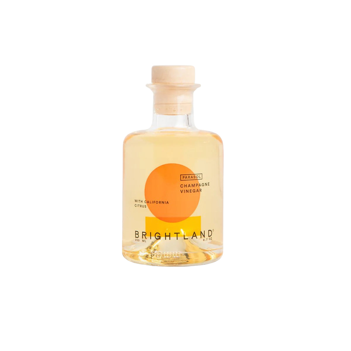 Brightland Patio 48% Champagne Vinegar in a clear glass bottle with a cork stopper, featuring a label with an orange circle and yellow block on a white background.