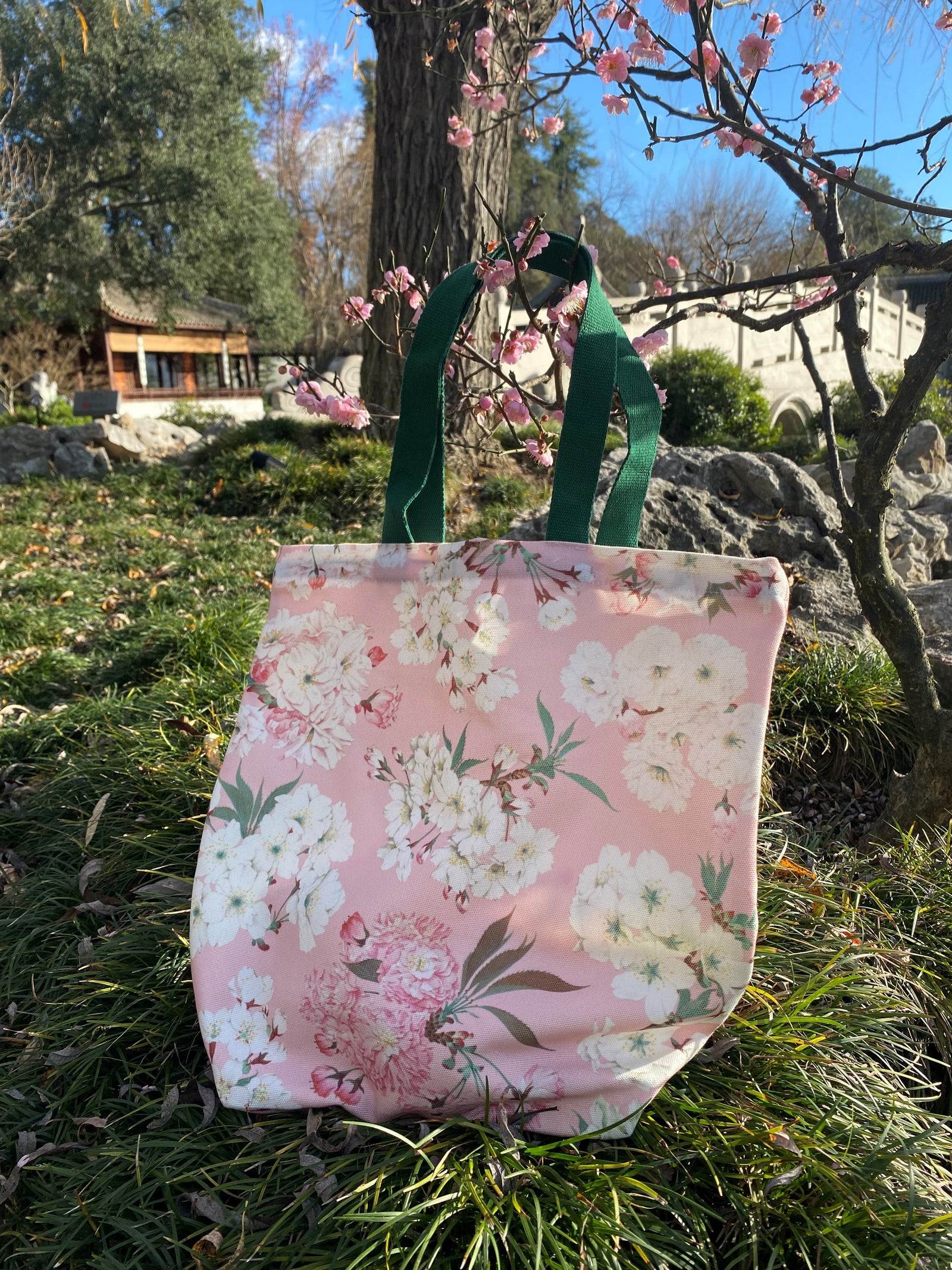 On February 14, 1912, a shipment of 3,020 cherry trees of twelve varieties was sent as a gift of friendship to the city of Washington D.C. from the city of Tokyo, Japan.  Eleven of those varieties are represented in the illustrations on this tote. 100% polyester canvas body, cotton handles. 15.'" x 15.5". Handles: 20".