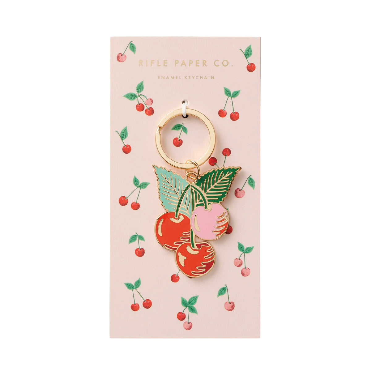 Cherry-themed keychain on Rifle Paper Co. packaging with cherry illustrations.