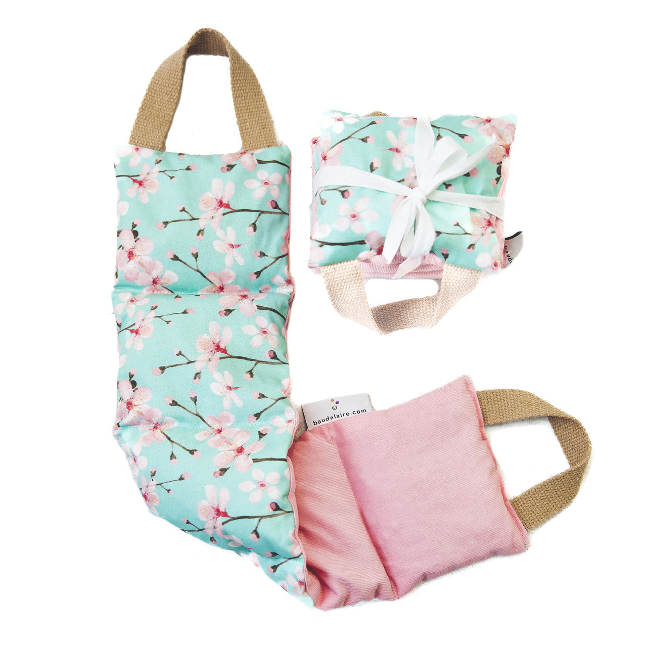 This therapeutic pillow is wrapped in a mint cherry blossom cotton fabric and backed with cozy pink corduroy. Suitable for hot and cold treatment anywhere on the body to release tension and soothe muscle aches. Filled with naturally cleaned cherry stones that are a by-product of domestic cherry farming. 5.5" x 20".