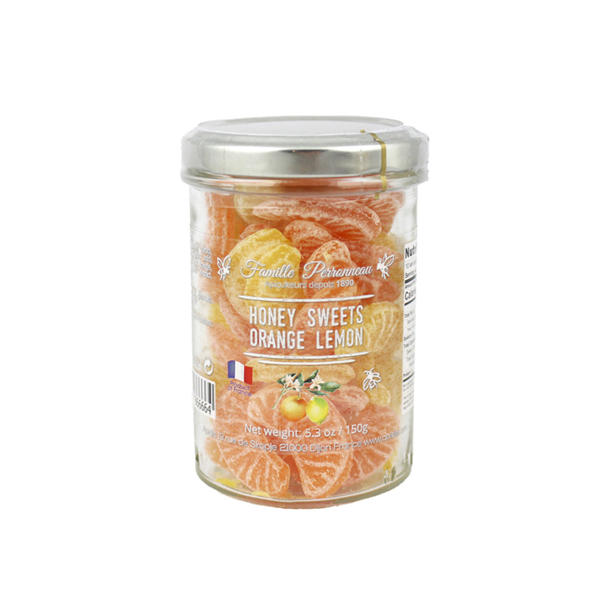 A glass jar of Famille Perrissonne Honey Sweets Orange Lemon, filled with orange and yellow citrus-flavored candies, topped with a silver metal lid, on a white background.
