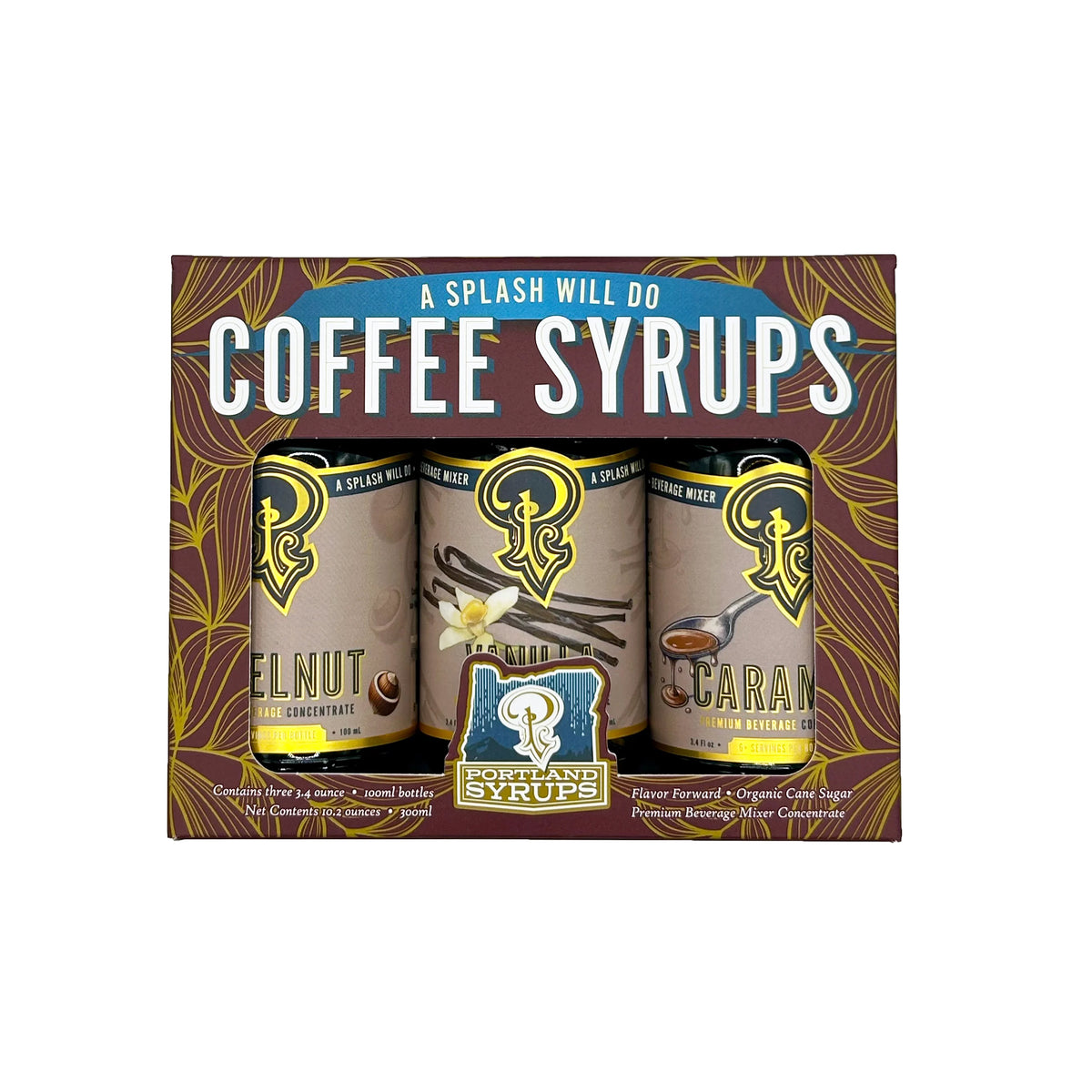 A boxed set of three coffee syrups from Splash Will Do, displayed in a retail box with decorative brown and gold artwork. The visible flavors are Almond Cream, Vanilla Bean, and Caramel.
