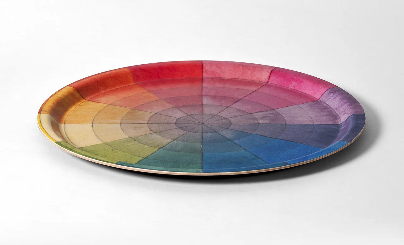 Serve in technicolor! Handcrafted in Sweden using birchwood certified by the Forest Stewardship Council (FSC), this round serving tray features a charming reproduction of Philipp Otto Runge's color wheel and is the perfect way to add personality into your home. Food-safe. Material: Birchwood Gicleé printed with water-based inks Circumference: 12"