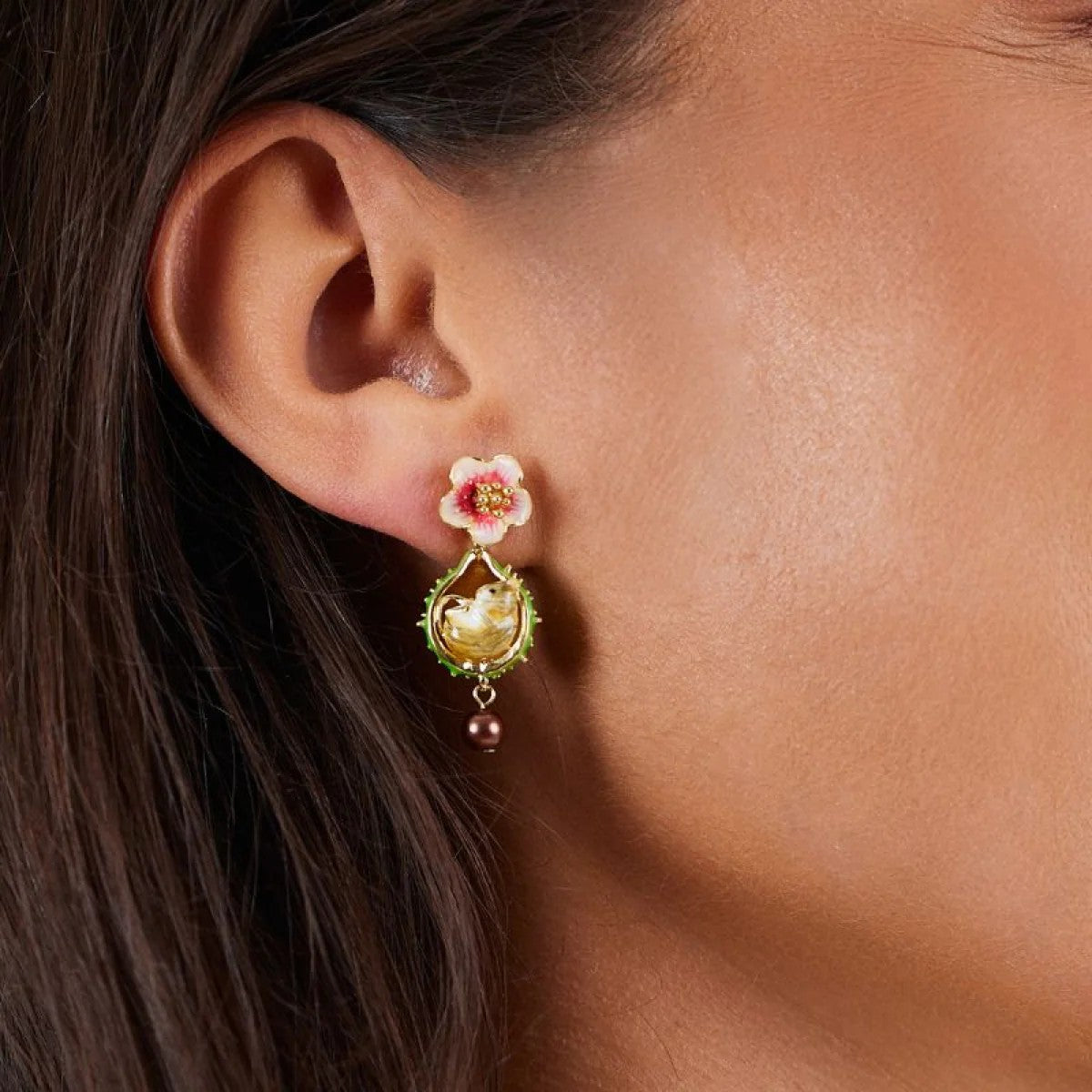 Pair of earrings with floral designs and mouse figures on a white background