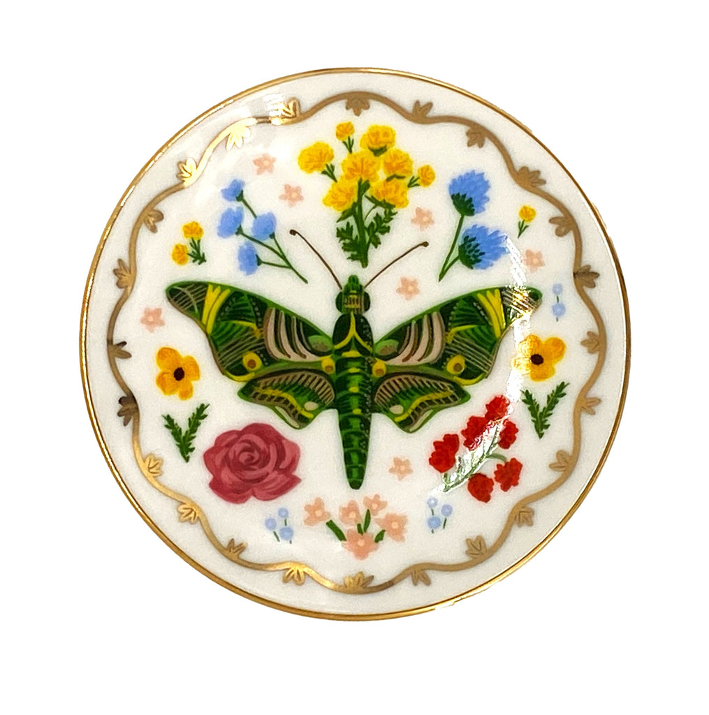 Keep this ring dish by your desk, the sink, or on your nightstand, and keep all your small, special things safe. This pretty porcelain dish features a botanical 'curio' design and a metallic gold rim for extra shine. Material: Porcelain Diameter: 4" Full-color illustration with metallic gold accents. Hand wash.