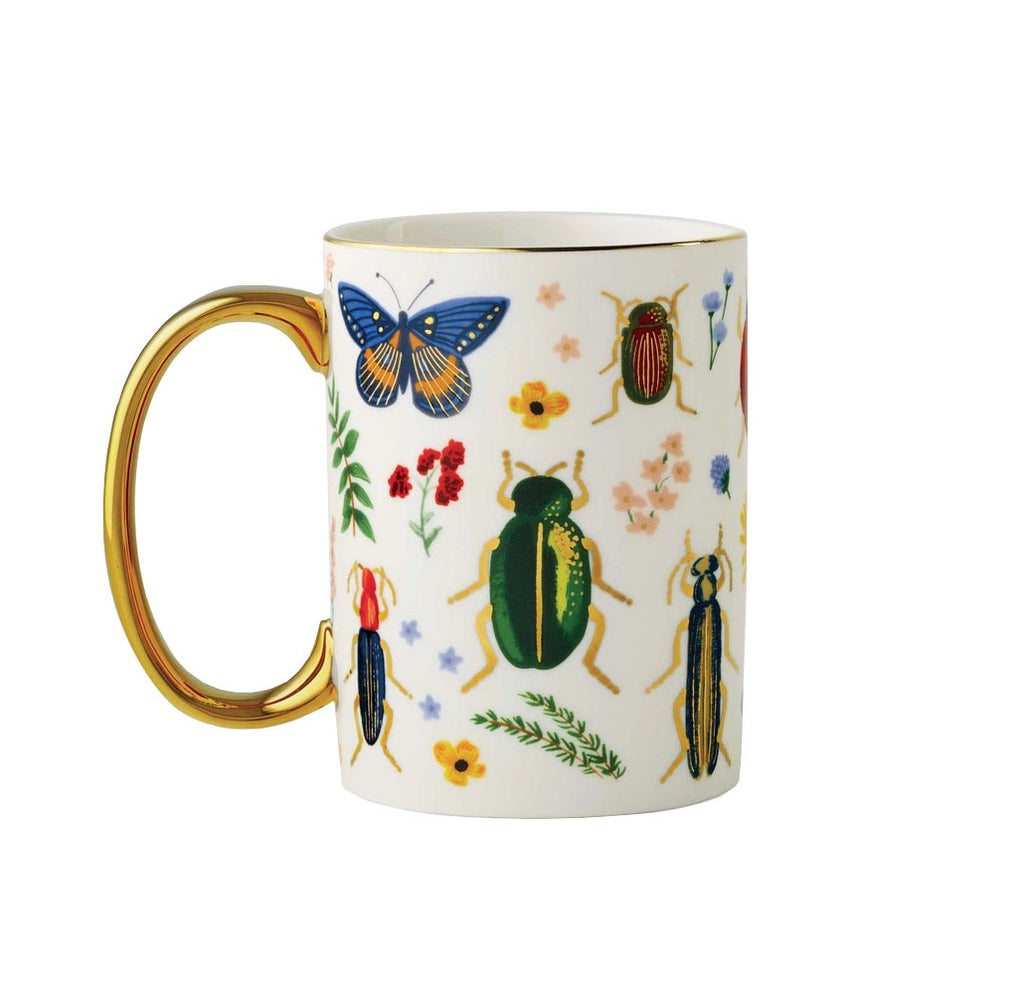 With an intricate design, bright colors, and gold accents, this colorful curio mug celebrates the beauty found in nature. This pretty porcelain mug also features a gilded rim and handle to add a little something special to your favorite beverage. Dimensions: 4.5" × 3.1". 16 oz. 
