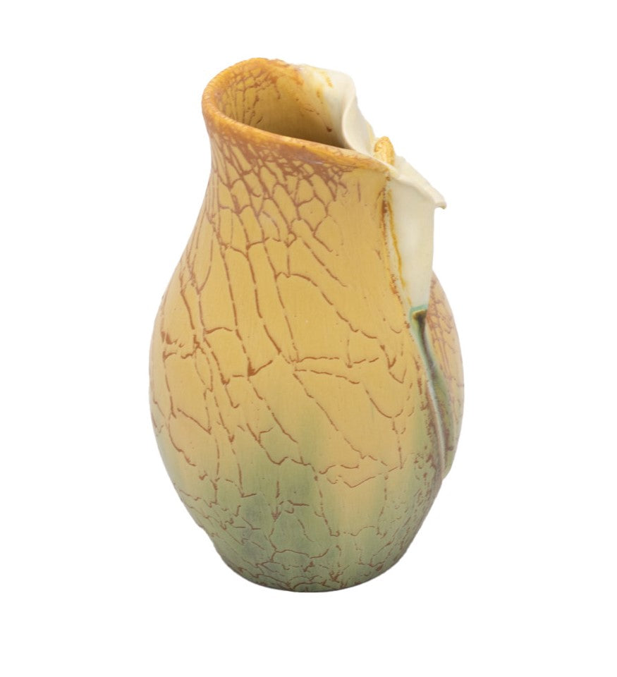 A handcrafted earthenware art pottery vase with a calla lily design, primarily in beige and green colors.