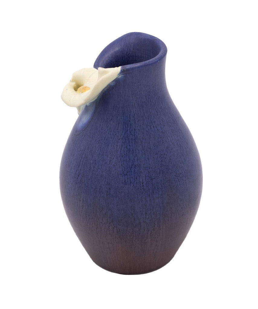 Blue ceramic vase with a white Calla Lily flower design on a white background