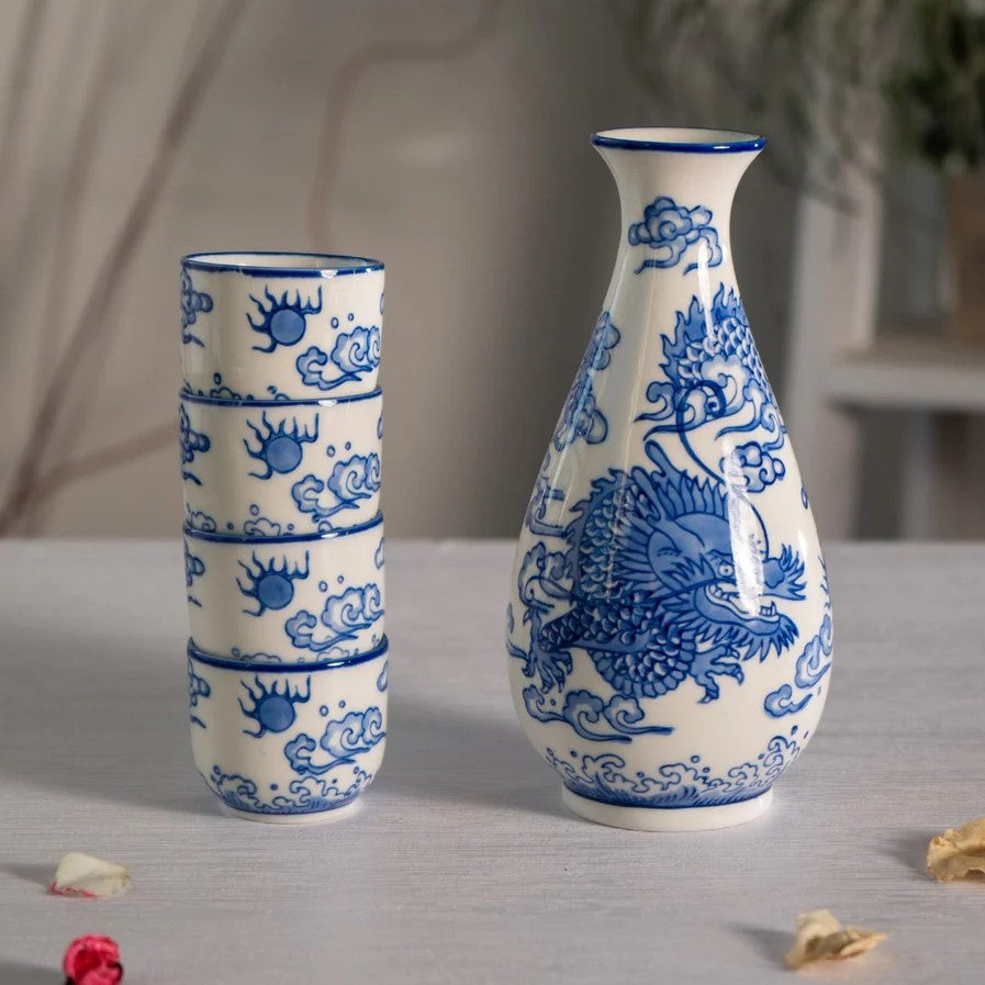 Ceramic sake set with blue floral patterns on a white background