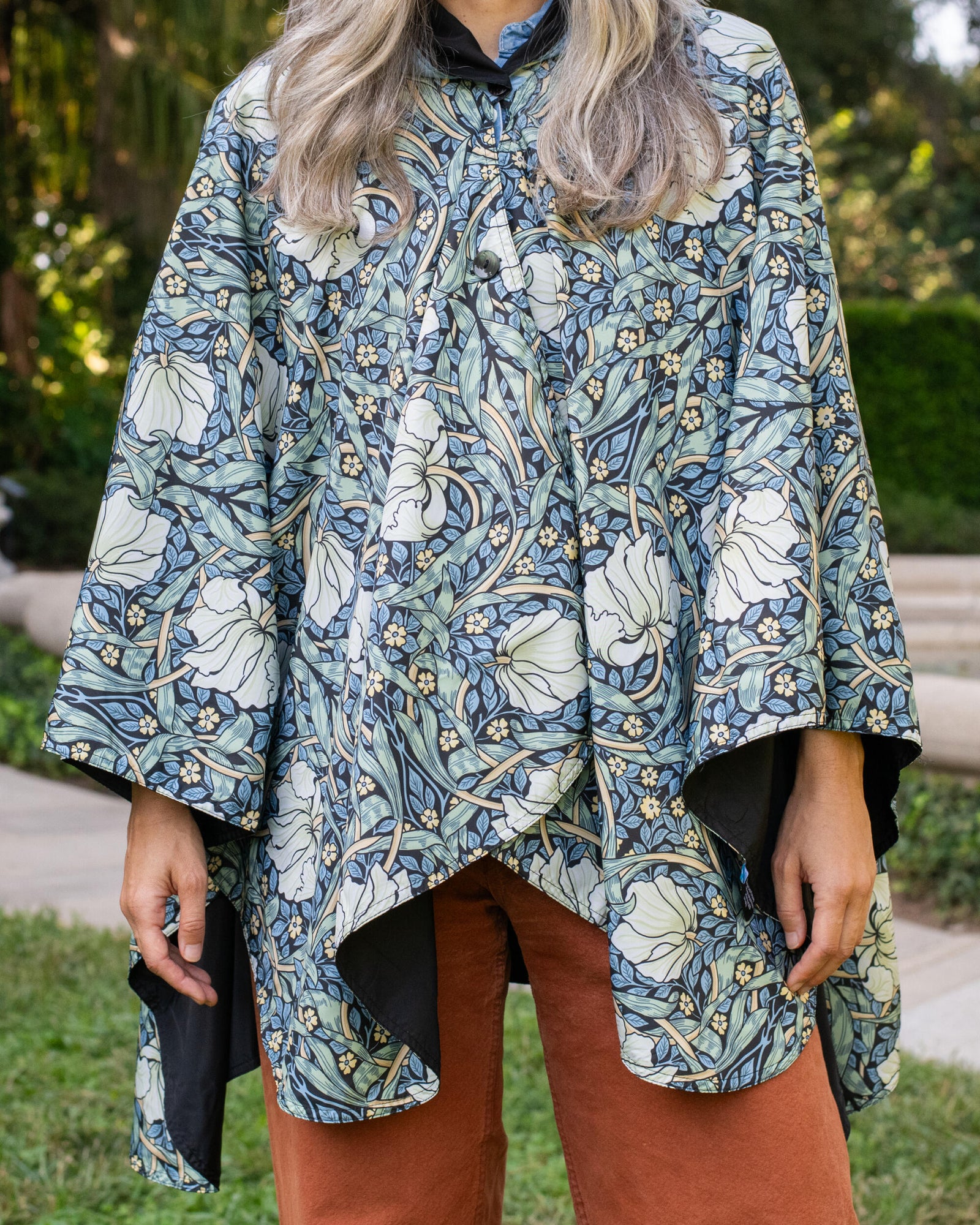 Floral patterned hooded poncho on a mannequin against a white background
