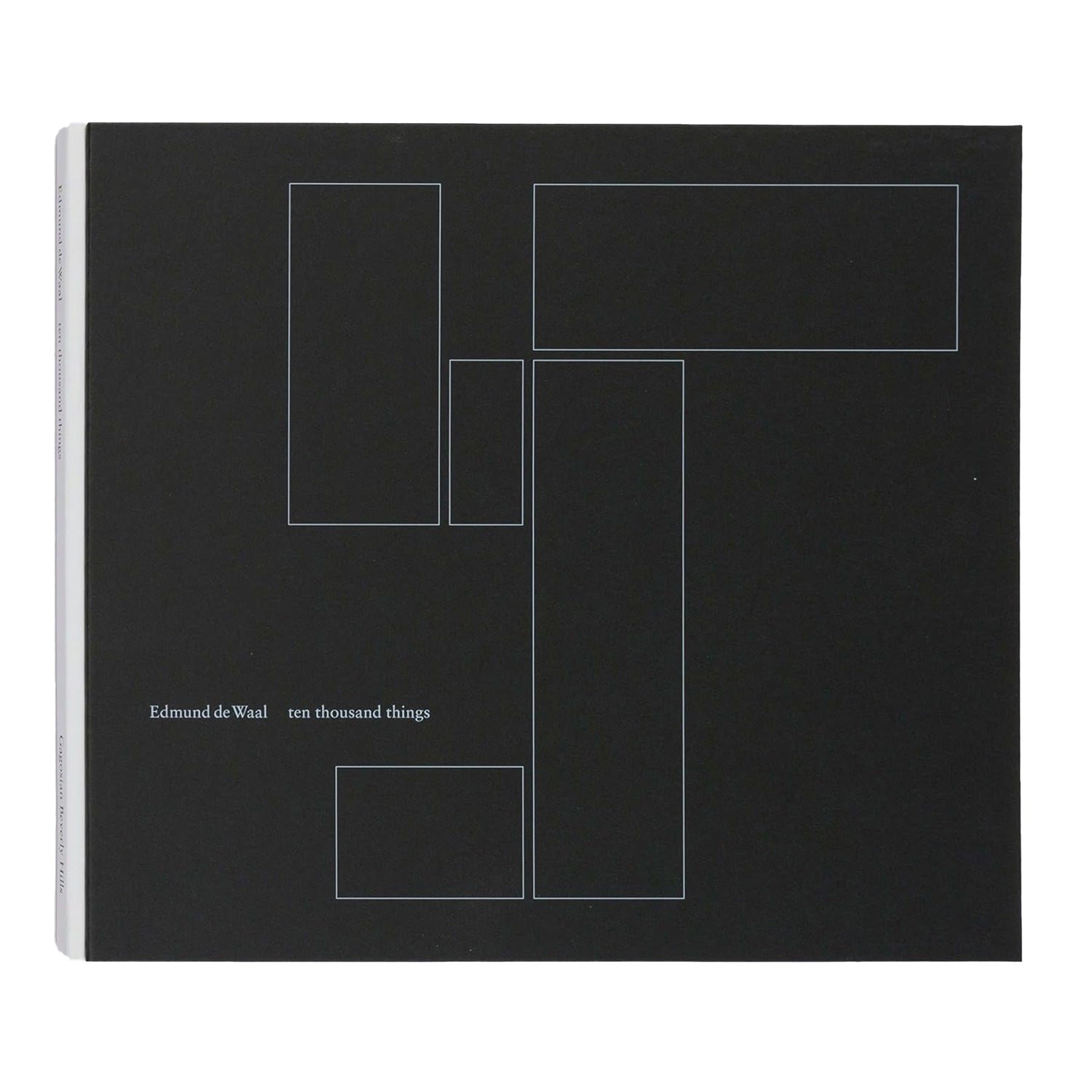 Black book cover OF 'Ten Thousand Things' by Edmund De Waal with white geometric line design and text on a white background