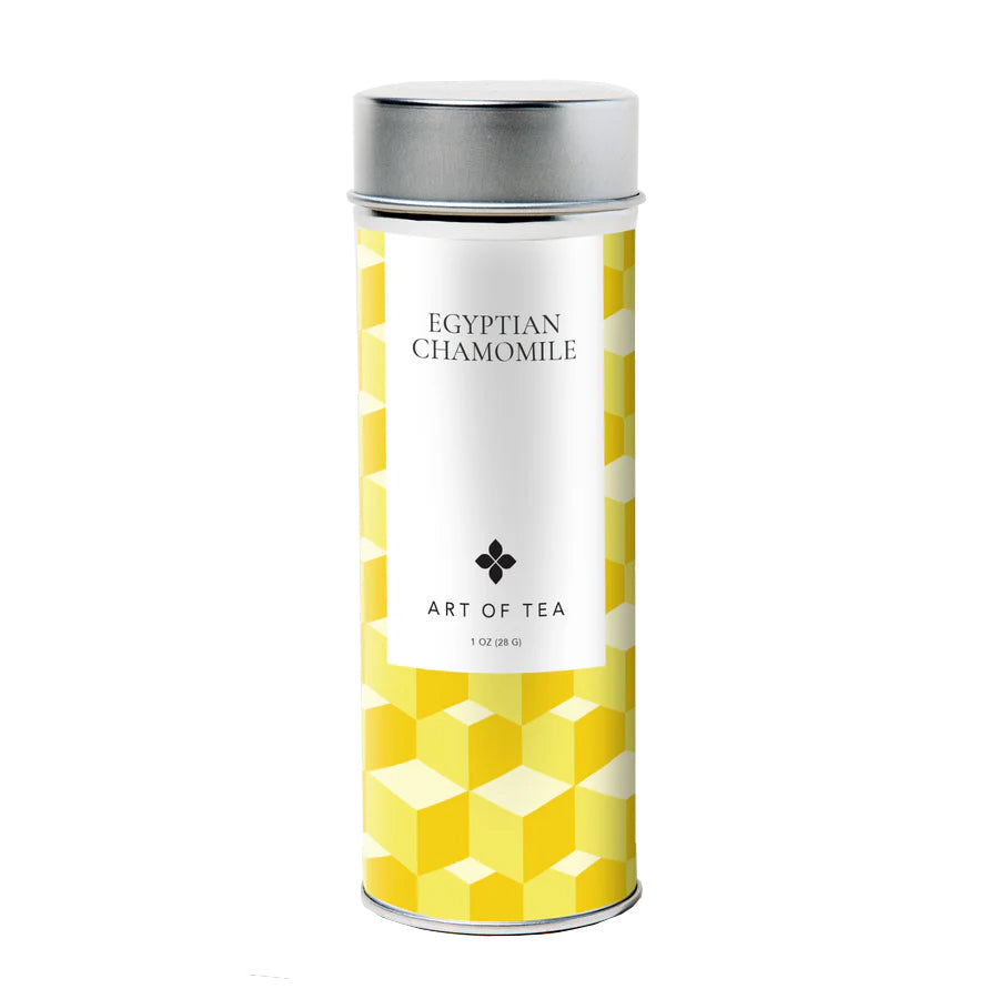 A tall yellow patterned tea canister containing loose-leaf chamomile tea