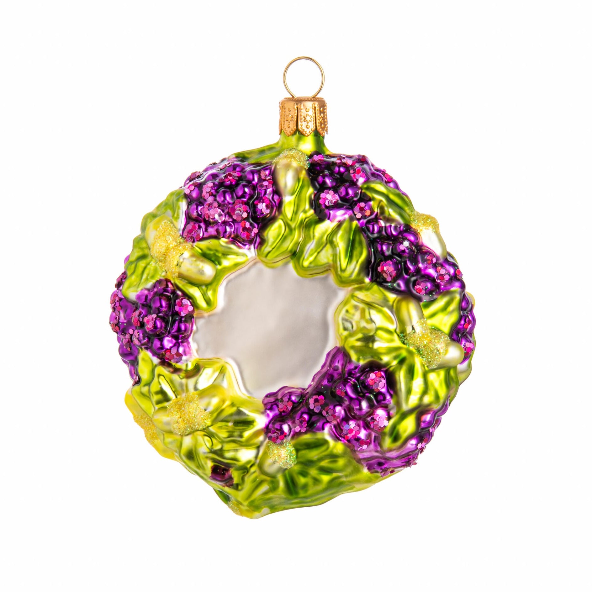Purple and green wreath shaped glass Christmas tree ornament on a white background. 