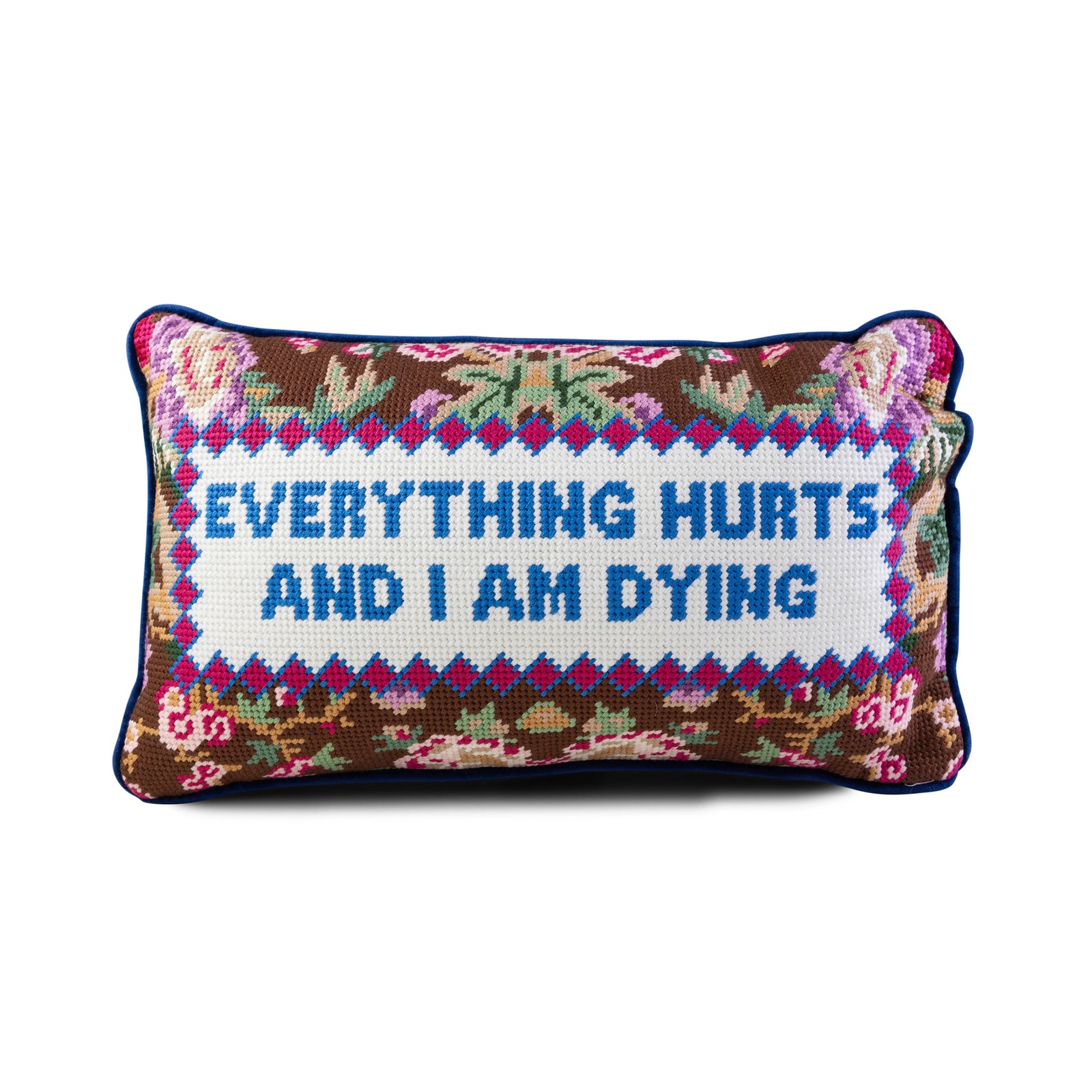 Decorative pillow with embroidered text 'Everything hurts and I am dying' on a white background