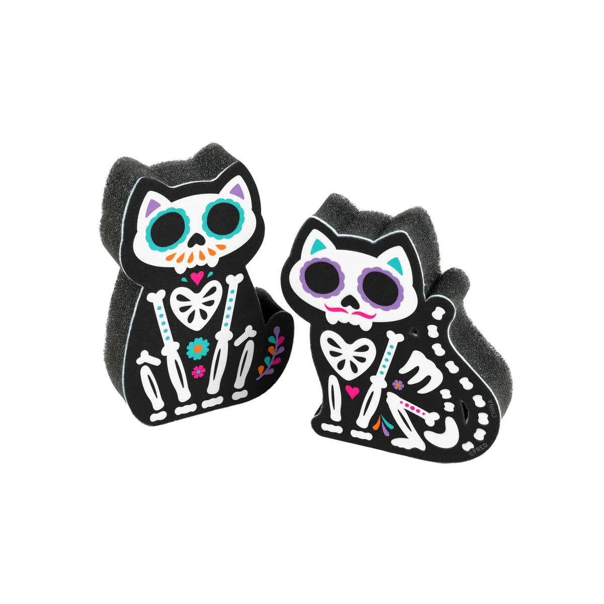Two black cat-shaped foam bath sponge toppers featuring colorful Day of the Dead cat skeleton designs, shown on a plain white background.