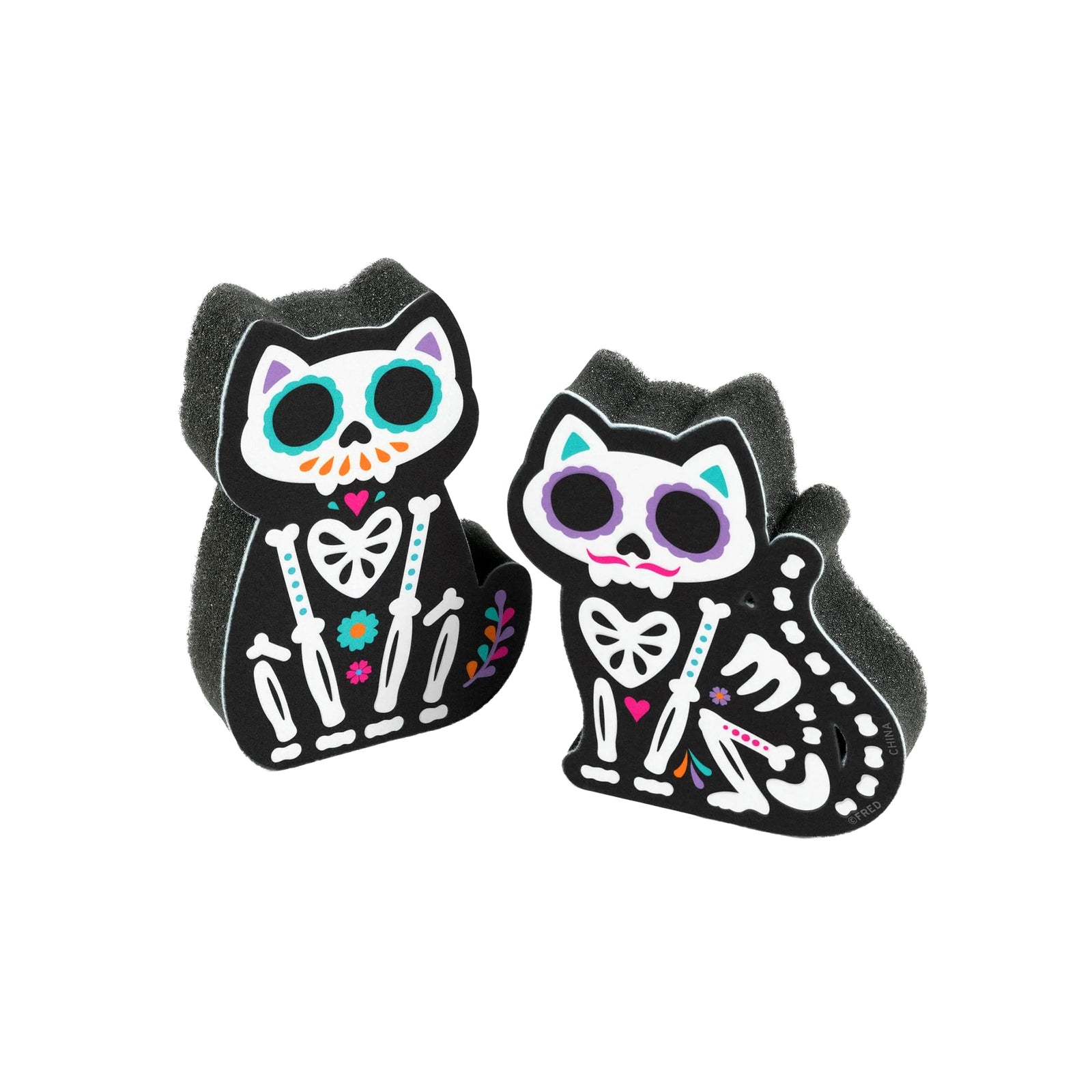 Two black cat-shaped foam bath sponge toppers featuring colorful Day of the Dead cat skeleton designs, shown on a plain white background.