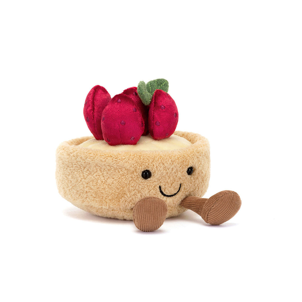 A plush strawberry tart toy Amueables Jellycat Fleurette with a beige fuzzy crust, red strawberries on top with green leaves, a smiling embroidered face, and brown corduroy legs, photographed on a clean white background.