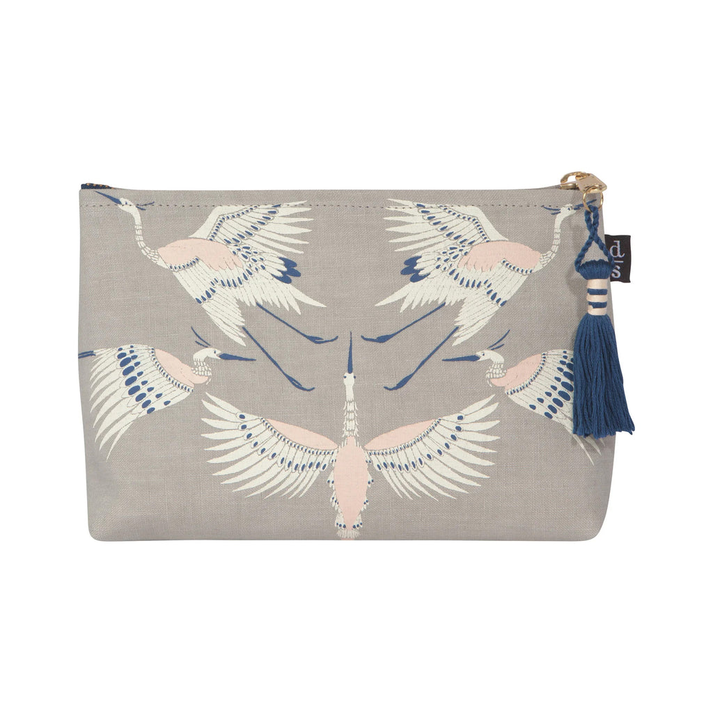 A timeless print of birds in motion. Worldly and full of grace, this aerial assembly of Cranes is elevated by the intricate linework on this design. Printed onto a vintage style grey linen base and finished off with a metallic gold zipper and midnight blue tassel. 9 x 5 inches. 100% Linen with Vegan Leather Lining. 