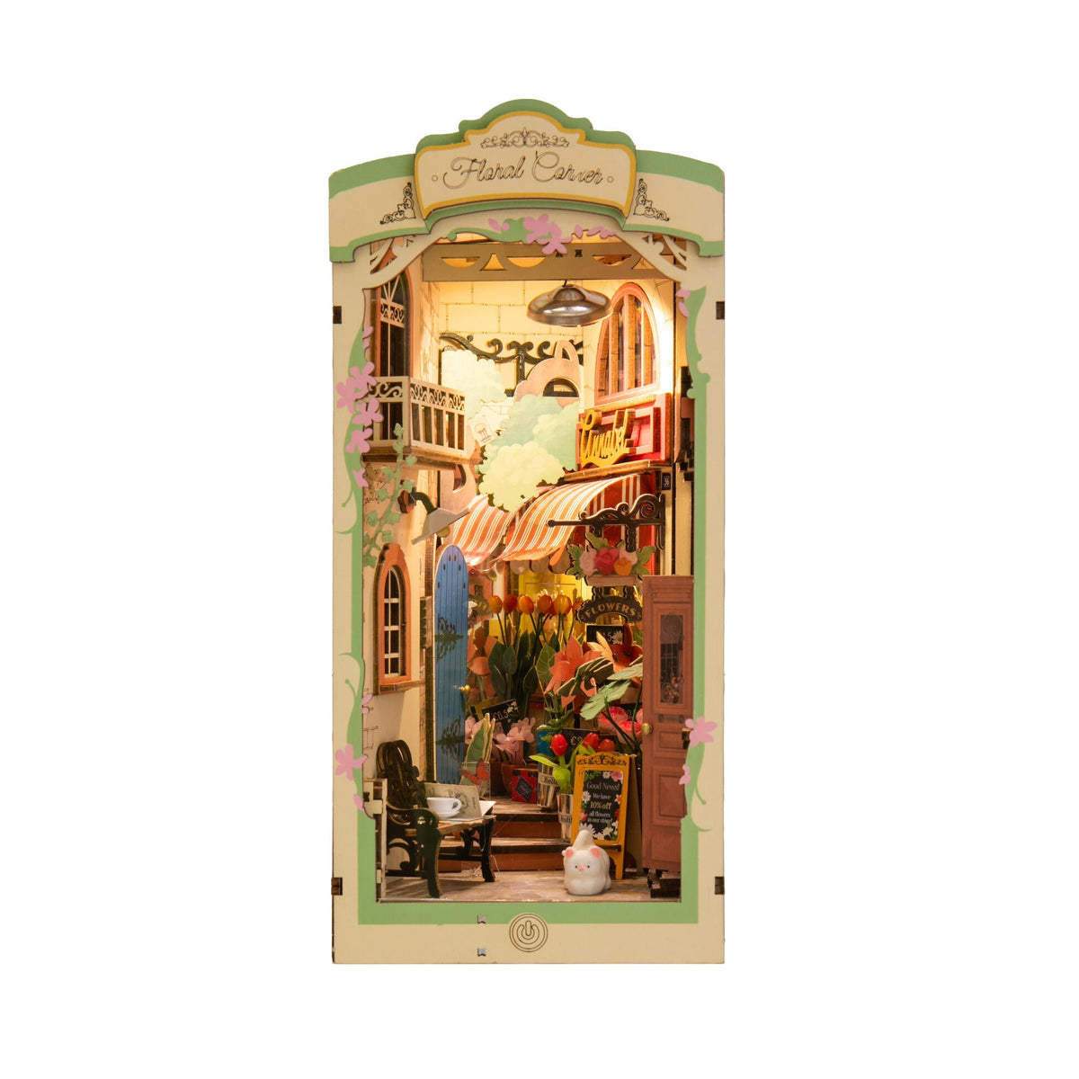 Model of a quaint street scene with a store and people on a white background