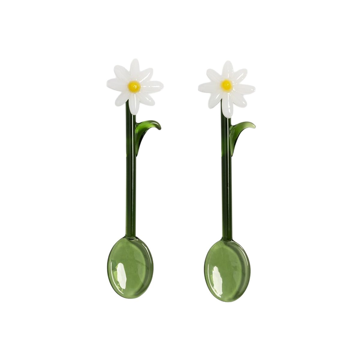 Two green spoons with daisy flower ends on a white background
