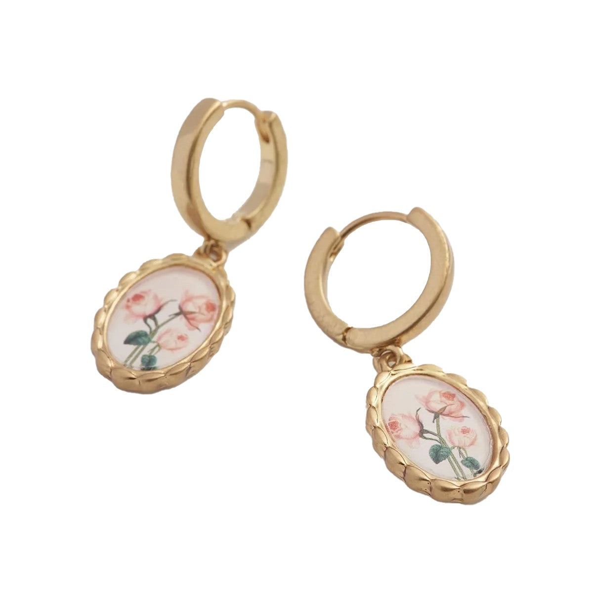 Experience the allure of Victorian elegance with these Framed Roses Huggies. These delicate pendants, featuring Dr Robert John Thornton's painted rose illustrations, hang from lobe-hugging hoops set in a timeless gold-tone oval hand-carved frame.