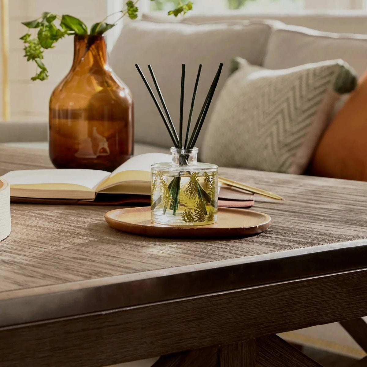 Diffuser with reeds on a wooden table in a living room setting