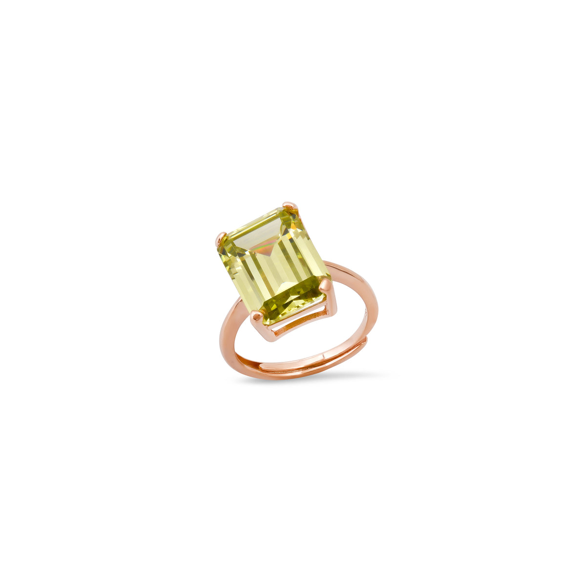 Ring with a chartreuse gemstone and rose gold band on a white background