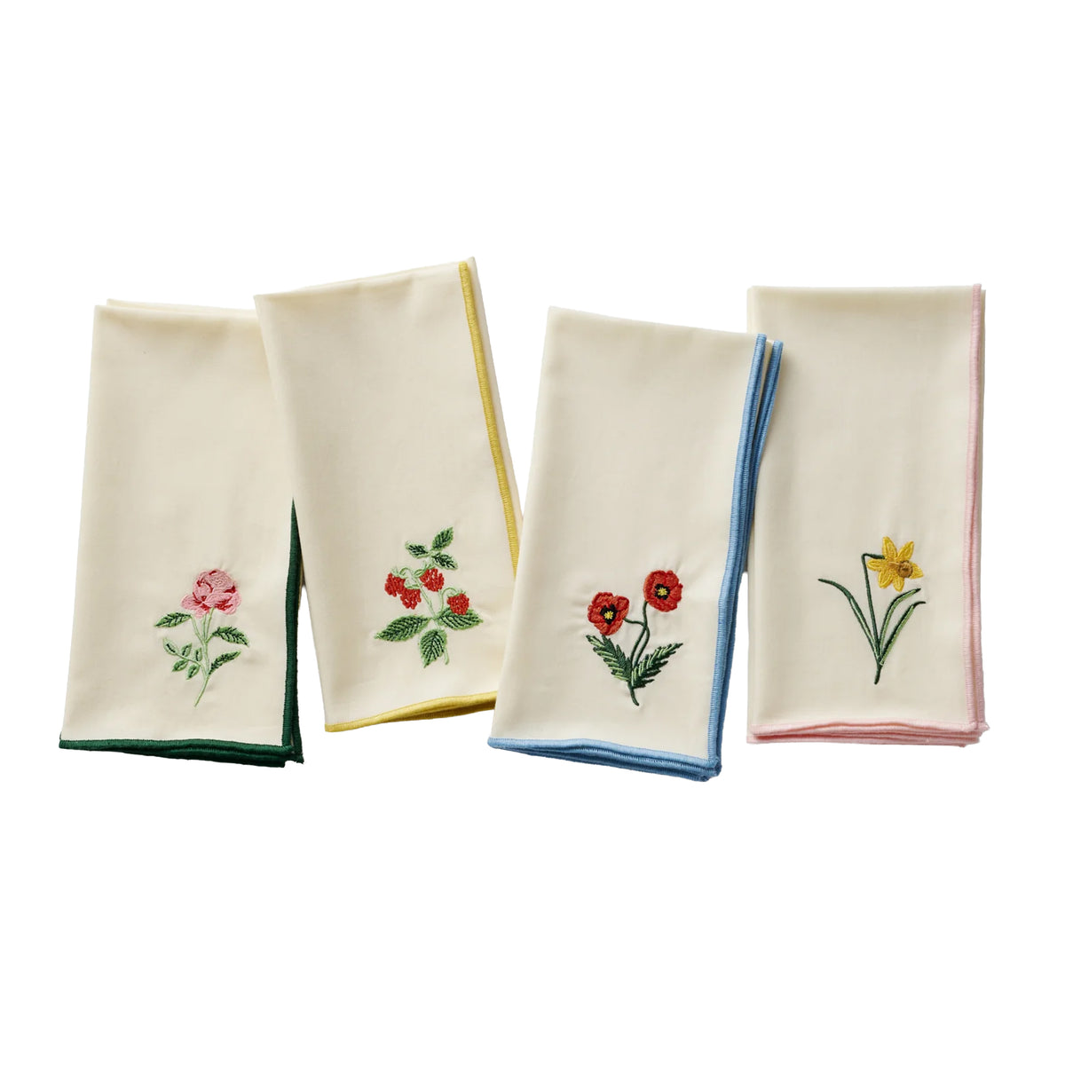 Four embroidered napkins with floral designs on a white background