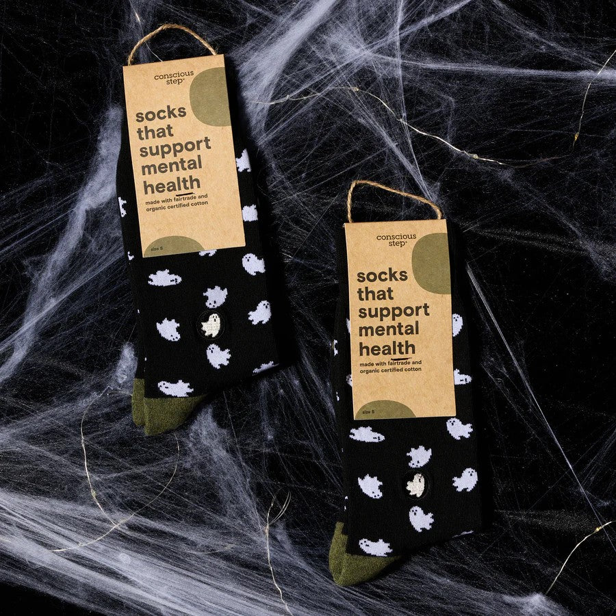 Black socks with white ghost patterns on a white background