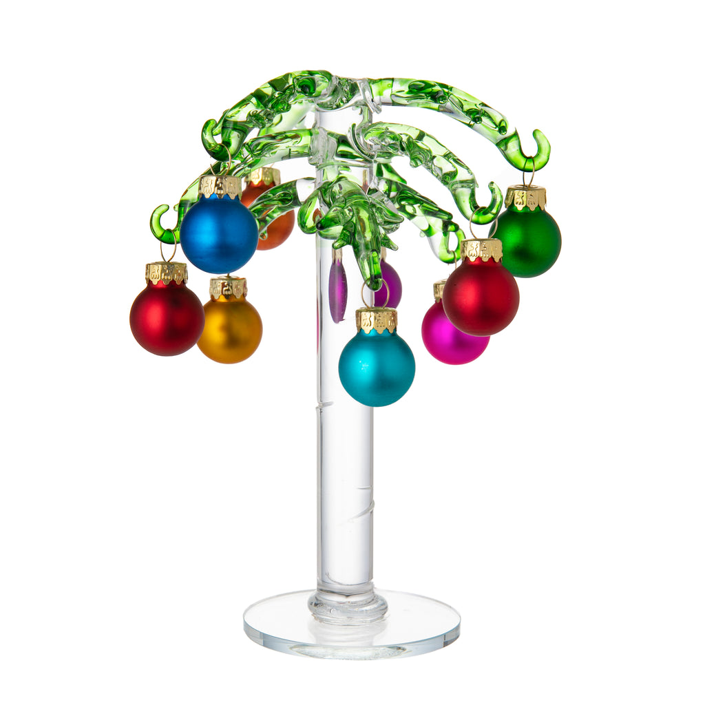 This hand-crafted glass palm tree makes a fun decor piece, keeping a touch of summer in your home, year-round. Decorate with the miniature glass ornaments included or add your own ornaments. Great as a table centerpiece, or to display jewelry.  4.33" (D) x 4.33" (W) x 6.69" (H) Includes 9 miniature glass ornaments.