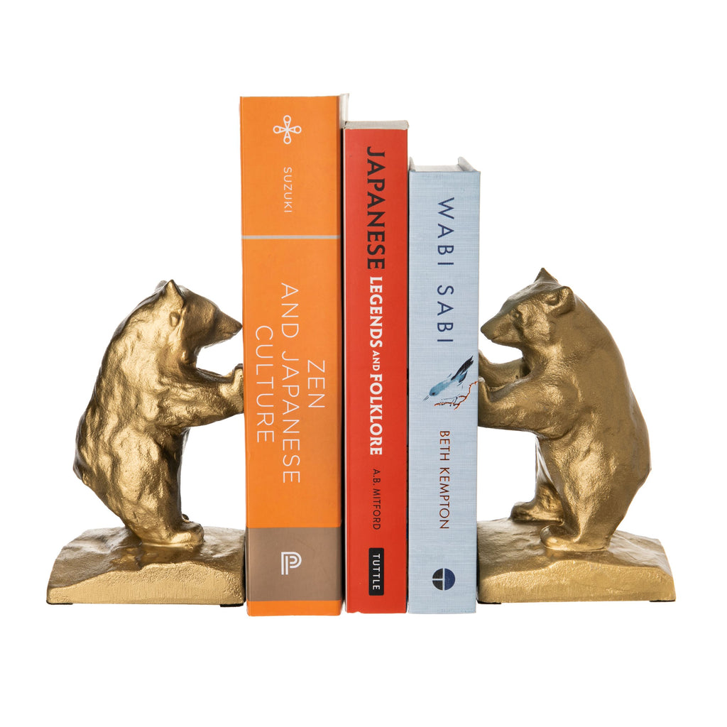 Add some California Chic to your bookshelf with these gilded iron, bear bookends.   Heavyweight and exceptional quality, these can also be used as paperweights, table decor or doorstops.   Solid iron bookends Set of two in a presentation gift box Dimensions: 3 3/4" x 2 3/4" x 5.5" Made in Japan * Books not included.