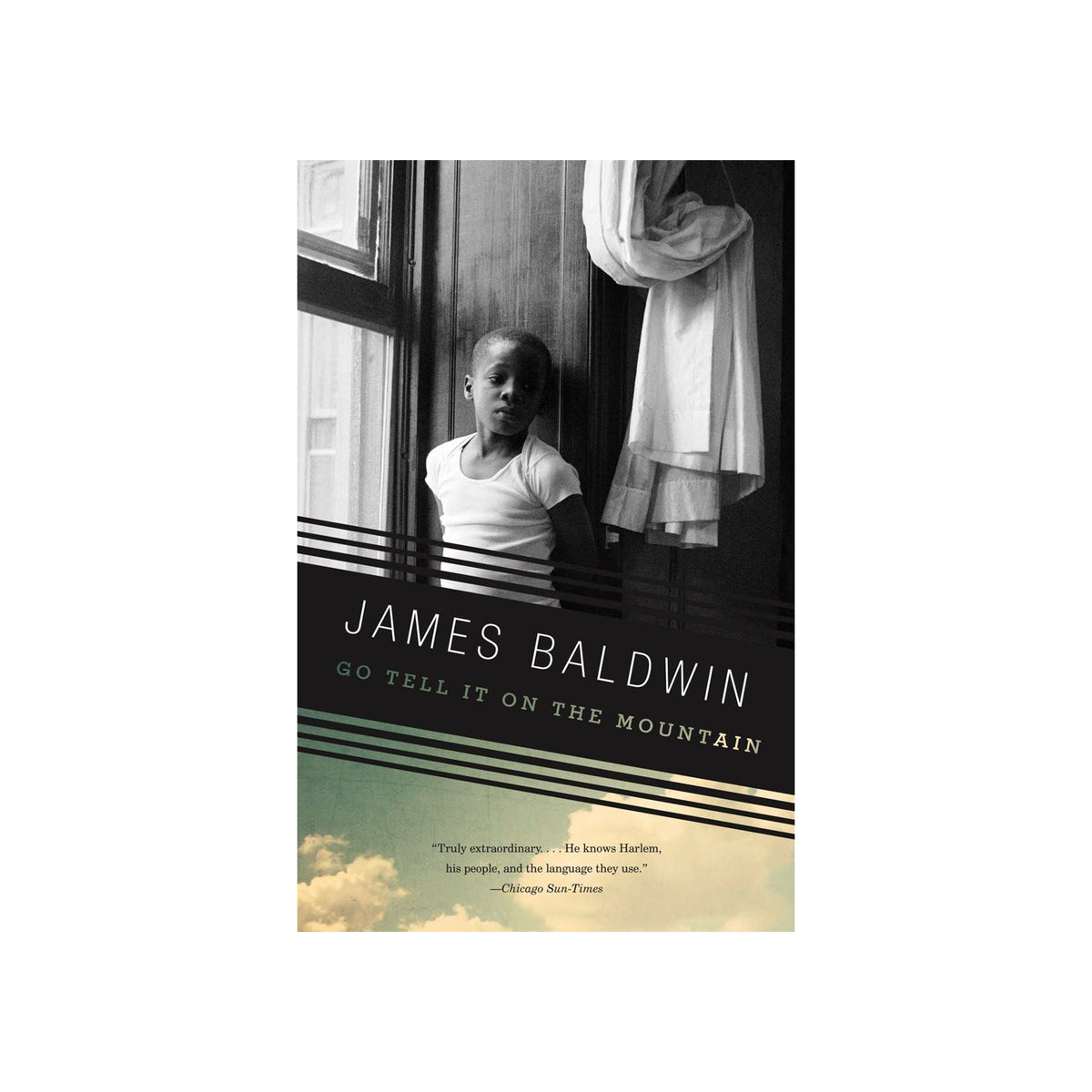 Book cover of 'Go Tell It on the Mountain' by James Baldwin with a black and white photo of a young boy.