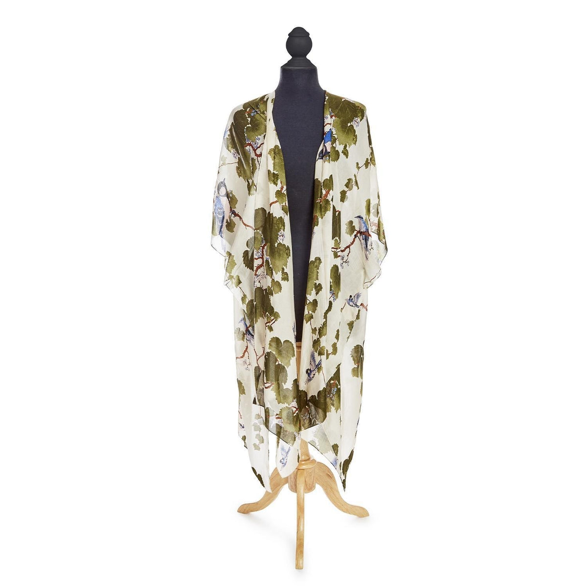 A long kimono style cover-up cardigan with a print of leafy branches and birds on a white background